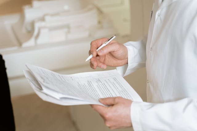 Financial consultant signs debt relief paperwork.