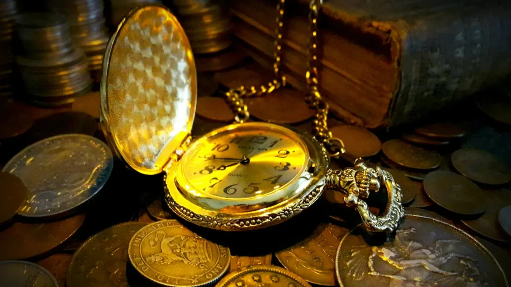 A gold pocket watch lying on a pile of old coins, the cost and the time of a consumer proposal against a bankruptcy